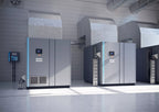 Industrial air conditioning units in a large room with concrete walls and floor.